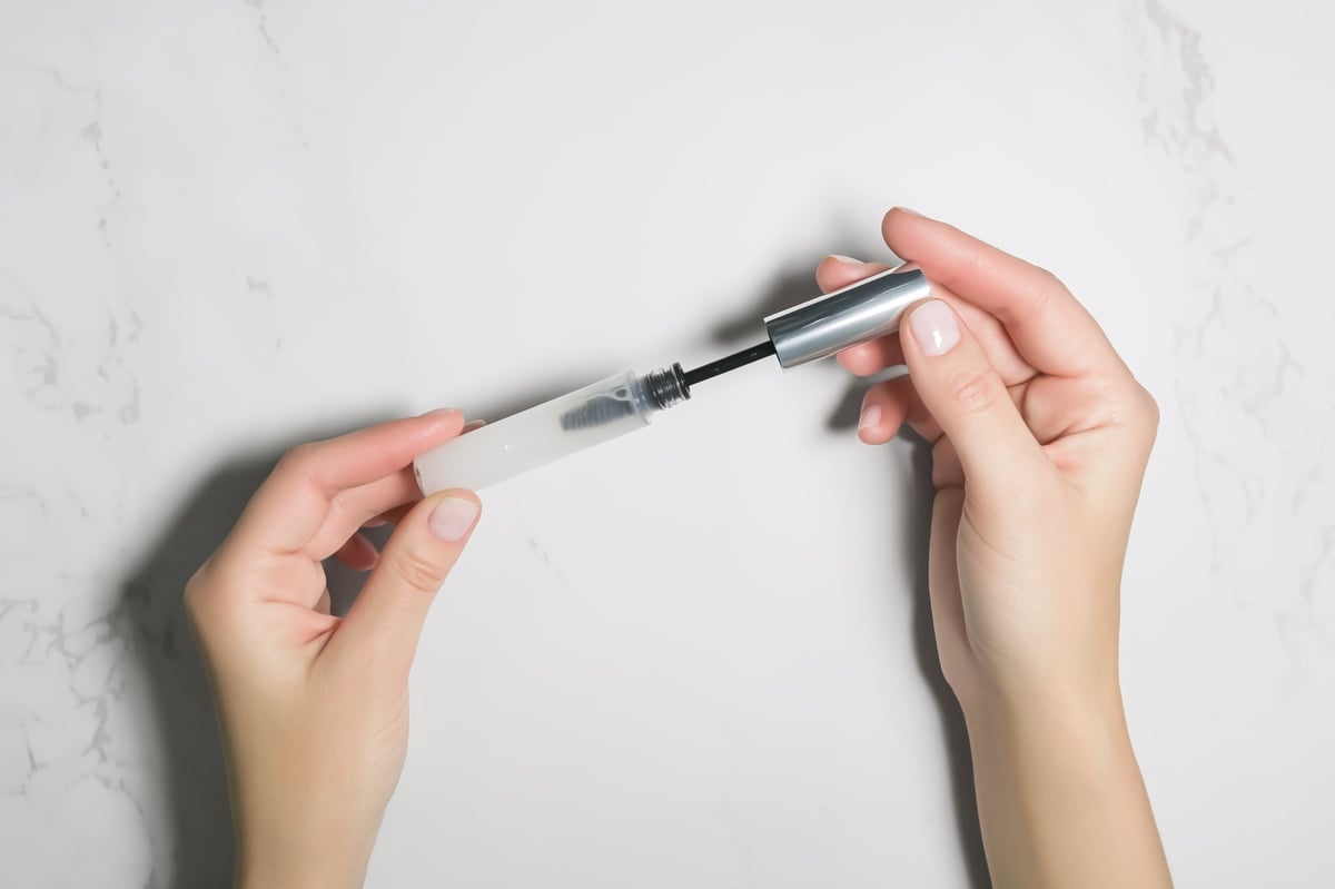 hands open eyelash and eyebrow growth serum